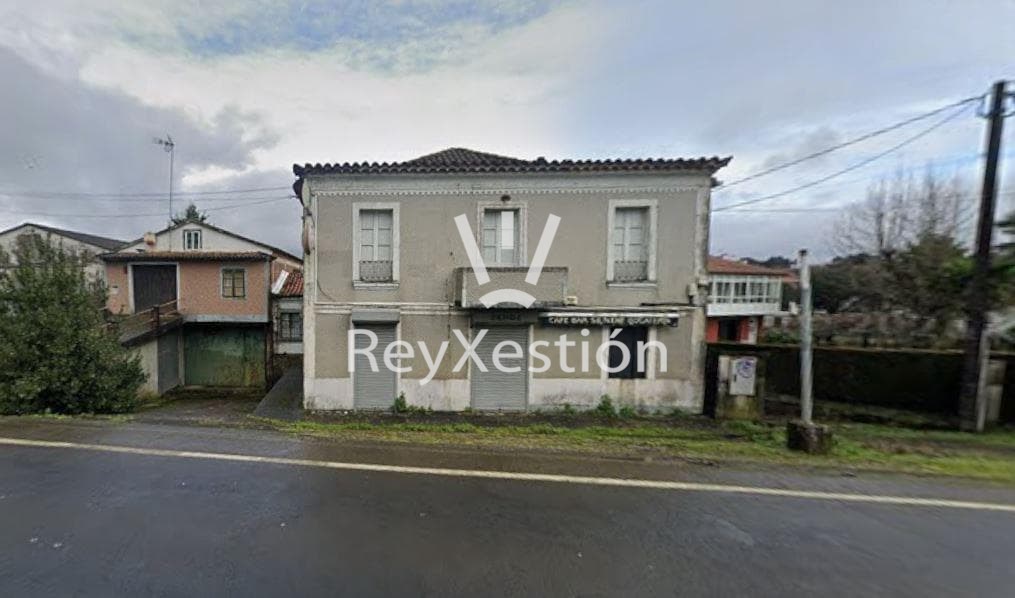 Foto 1 CASA UNIFAMILIAR DE PEDRA (con terreno e dúas naves multiuso) en Lavacolla